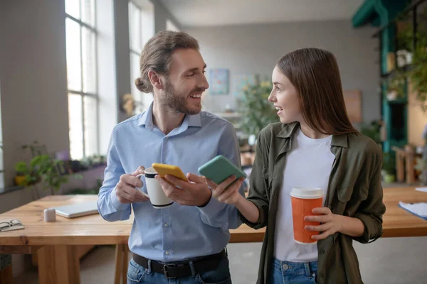 A couple walking at office while having coffee